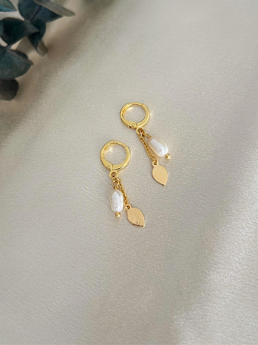 Pendientes delicados largos con cadena, perlas y dije de pétalo u hoja. Chapados en oro e hipoalergénicos. Regalo perfecto para mujer. Trópico Jewelry